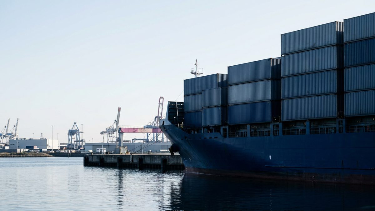 Unbranded cargo vessel at a European import terminal