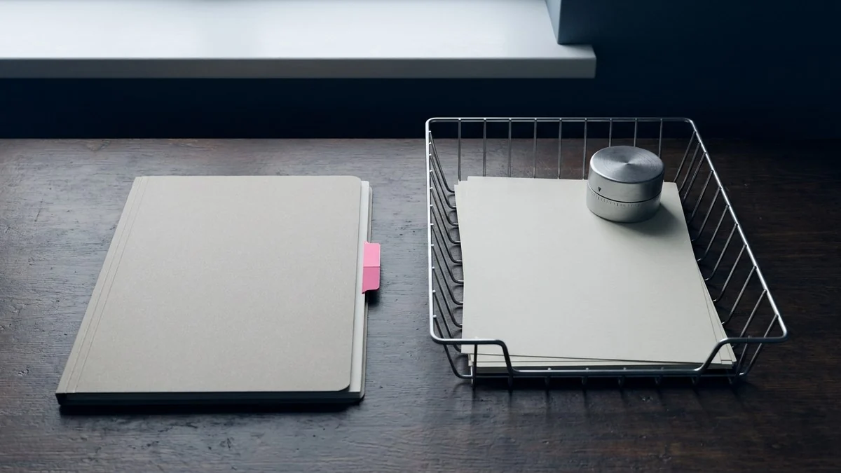 A closed archival folder separated from blank workflow cards and an unmarked timer on a purchasing operations desk.